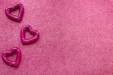 Concept of Valentine's Day with red hearts glitter red background, top viewの写真素材