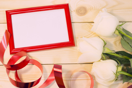 White roses on natural wooden background