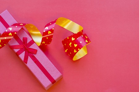 The concept of St.Valentine's Day with a gift box, red background top viewの写真素材