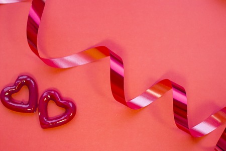 The concept of St.Valentine's Day with red hearts and ribbon, red background top viewの写真素材
