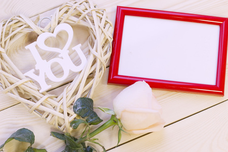 Wooden background with a cream rose