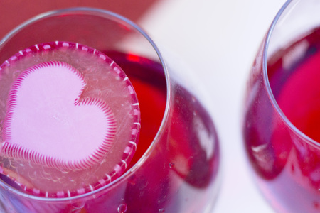 The concept of Love, Wedding, Proposal, Anniversary. A romantic surprise with two glasses of red wine, light background . Top view, close upの写真素材