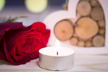 The concept of St.Valentines day with a red rose and candleの写真素材