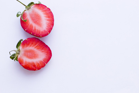 Healthy Food Berries and Fruit,Dessert Concept. A close up of cut in halves strawberries on white, copy spaceの写真素材