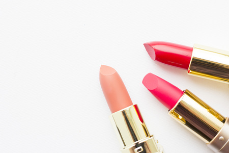 Make Up Beauty Fashion Concept. Matte red, pink and beige lipstick on white background, top view, flat layの写真素材