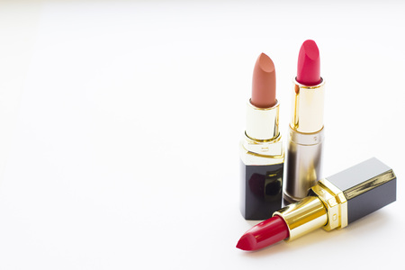 Make Up Beauty Fashion Concept. Matte red, pink and beige lipstick in black tubes on white backgroundの写真素材
