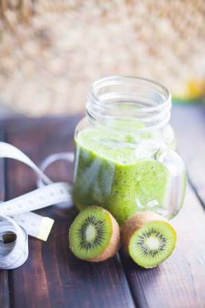 Healthy green smoothie on a dark wooden backgroundの写真素材