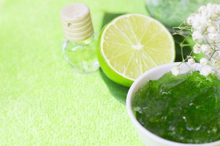 Fruit aromatherapy spa concept with essential oil in glass bottles, soap bars, jelly lotion and lime...
