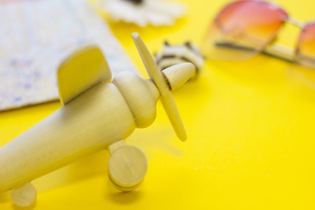 Wooden toy airplane on yellow tableの写真素材