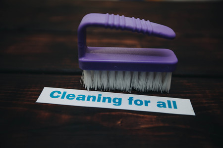 Cleaning house or office concept. Purple cleaning brush, Cleaning for all inscription on a dark wooden background. Top view, closeupの写真素材