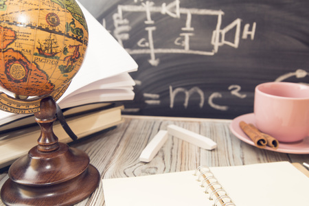 Physics lesson: Books on a black chalkboard