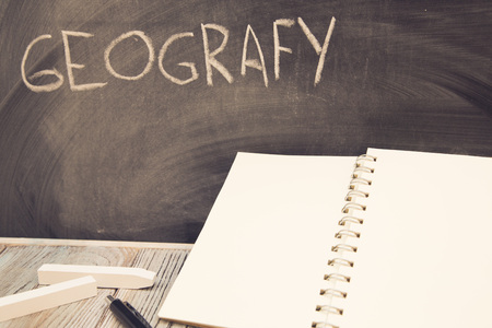 Books on a black chalkboardの写真素材