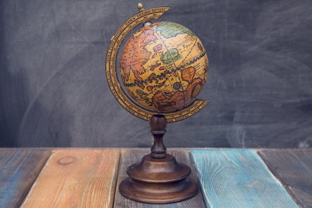 Globe on a black chalkboardの写真素材