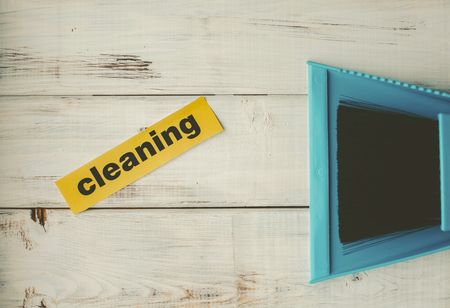 Sweeping dust pan and brush set. Bright composition with blue plastic cleaning tools on a blue background. Close upの写真素材