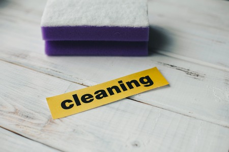 Cleanup in a kitchen. A bright abstract composition with scrub dishwashing sponges on a white wooden...