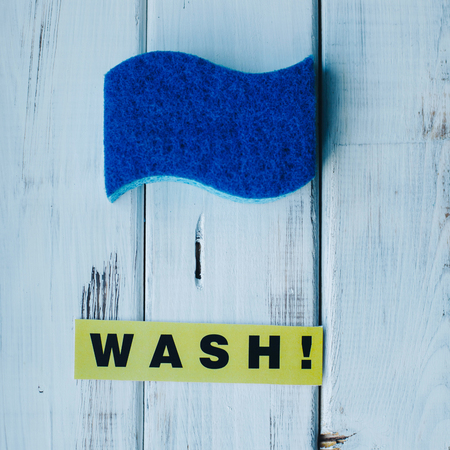 Cleanup in a kitchen. A bright abstract composition with scrub dishwashing sponges on a white wooden background. Close upの写真素材