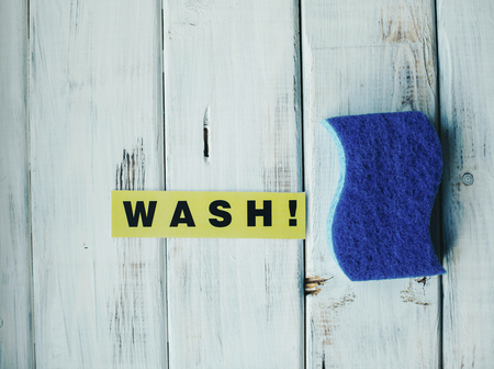 Cleanup in a kitchen. A bright abstract composition with scrub dishwashing sponges on a white wooden background. Close upの写真素材