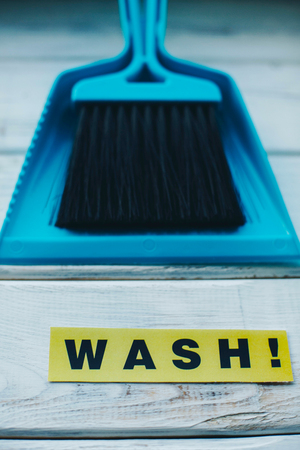 Sweeping dust pan and brush set. Bright composition with blue plastic cleaning tools on a blue background. Close upの写真素材