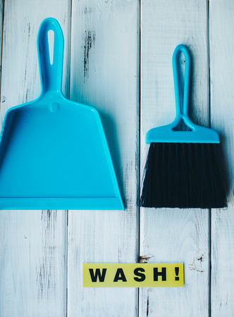 Sweeping dust pan and brush set. Bright composition with blue plastic cleaning tools on a blue background. Close upの写真素材