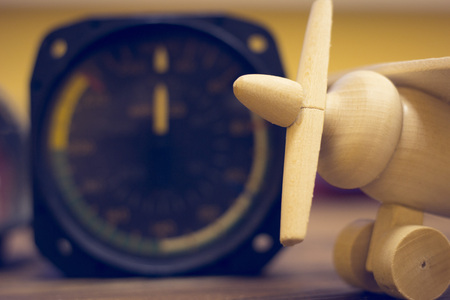 Travel, Sport Concept. A speed counter and a toy wooden plane on a blurred background, close upの写真素材