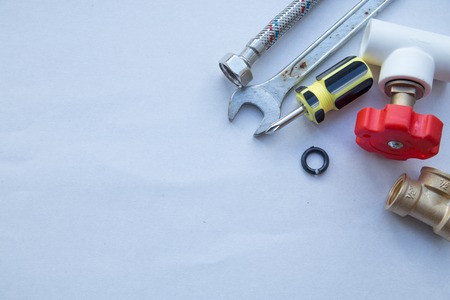 Various plumbers tools and plumbing materials including stainless steel, plastic and copper pipe,...