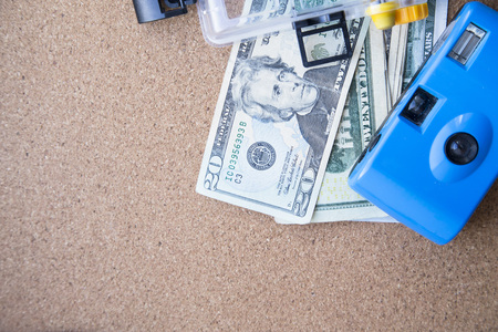 Preparing for vacation, travel or journey. Travel planning. Booking hotel. Sand background with us money, passport, seashells, camera and compass.の写真素材