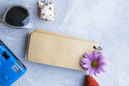 Preparing for vacation, travel or journey. Travel planning. Booking hotel. Grey marble background...