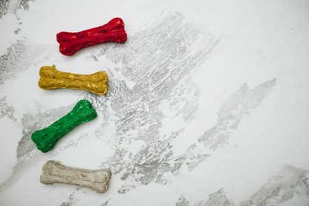 Dry pet food chewing bones on white stone background top view copyspaceの写真素材