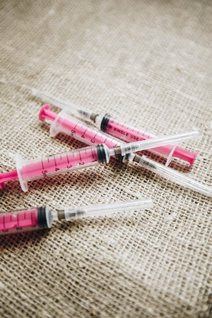 Pet medicine injection on dark canvas background top view copyspaceの写真素材