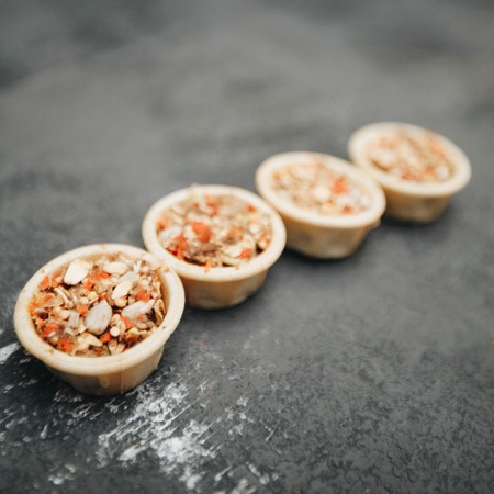 Dry pet food seeds on dark stone background top view copyspaceの写真素材