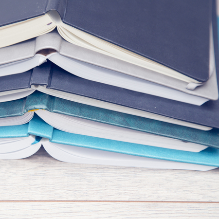 Books on wood board background. Education or business photo. Take note of the product for book with...