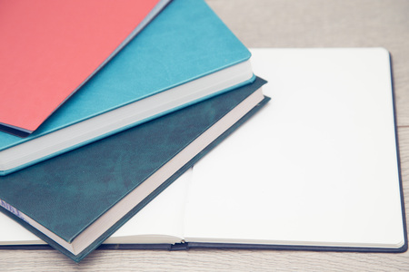 Notepad on wood board background. Education or business photo. Take note of the product for book...