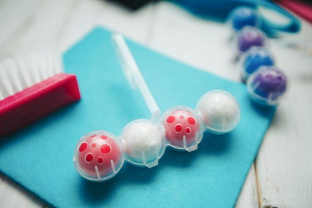 Cleaning house or office concept. A toilet freshener, rag and a purple plastic brushon a white...