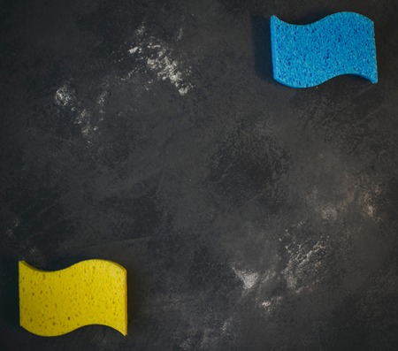 Cleaning house or office concept. Dark stone background with colorful sponges ,top view, flat layの写真素材