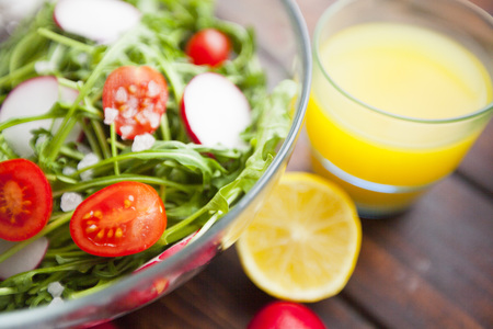 Healthy Breakfast, Sport, Fitness, Diet Concept. A bowl of salad with cherry tomatoes and a glass of...