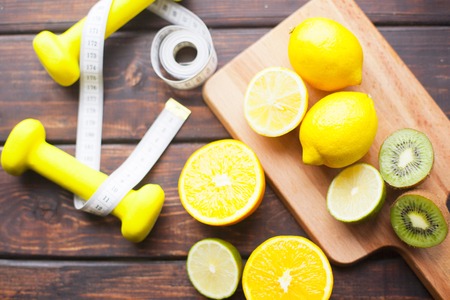 Healthy Breakfast, Sport, Fitness, Diet Concept. Citrus fruit on a wooden cutting board, yellow...