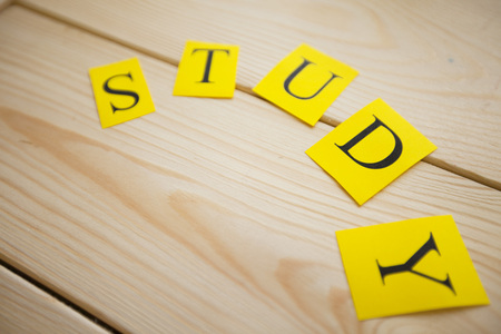 Education Creativity concept. STUDY inscription on light wooden background, top viewの写真素材