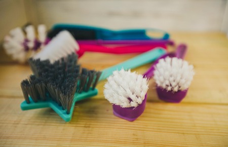 Healthy Lunch Concept. A green lunch box with sliced orange and kiwi, sandwich in a box, apple and banana, light wooden background, close up, top viewの写真素材