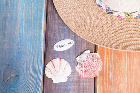 Preparing for vacation, travel or journey. Travel planning. A hat on colorfull wooden background.  top viewの写真素材