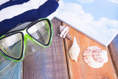 Preparing for vacation, travel or journey. Travel planning. Green swimming mask on colorfull wooden background.  top viewの写真素材