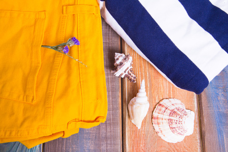 Preparing for vacation, travel or journey. Travel planning. Yellow jeans on colorfull wooden background.  top viewの写真素材