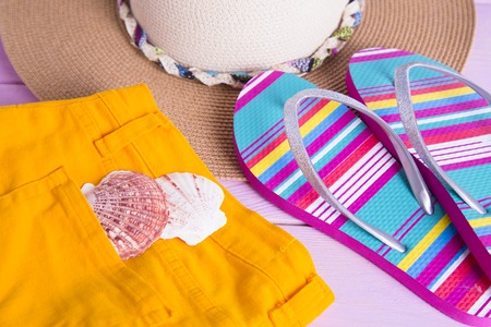 Preparing for vacation, travel or journey. Travel planning. Yellow jeans on white wooden background.  top viewの写真素材