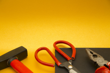Repair and renovation concept. A set of metal tools for repair with hammer, wrench and pliers on a...
