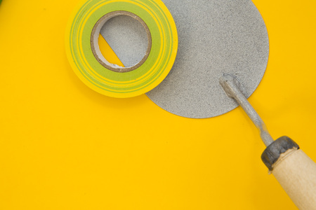 Tools for repair on plain yellow backgroundの写真素材
