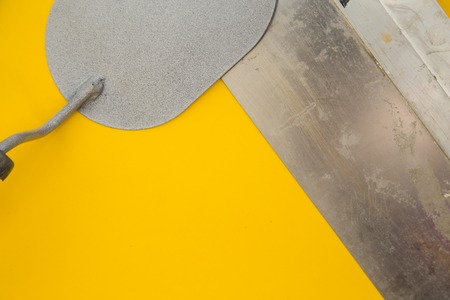 Tools for repair on plain yellow background
