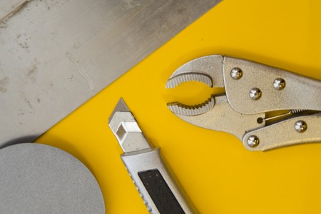 Tools for repair on plain yellow backgroundの写真素材