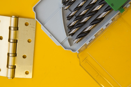 Tools for repair on plain yellow background