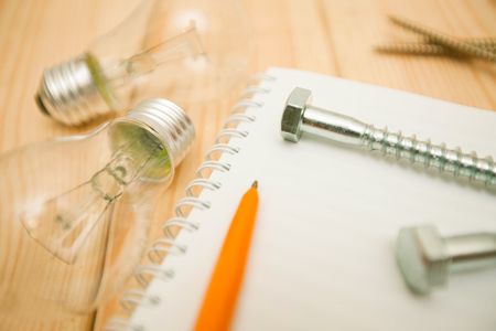 Repair carpenter tools: pens, notepad on white old wooden background, top view, copy space