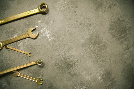 Repair modern tools: wrenches on dark stone background, top view, copy spaceの写真素材