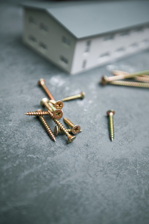 Repair modern tools: screws on dark stone background, top view, copy spaceの写真素材